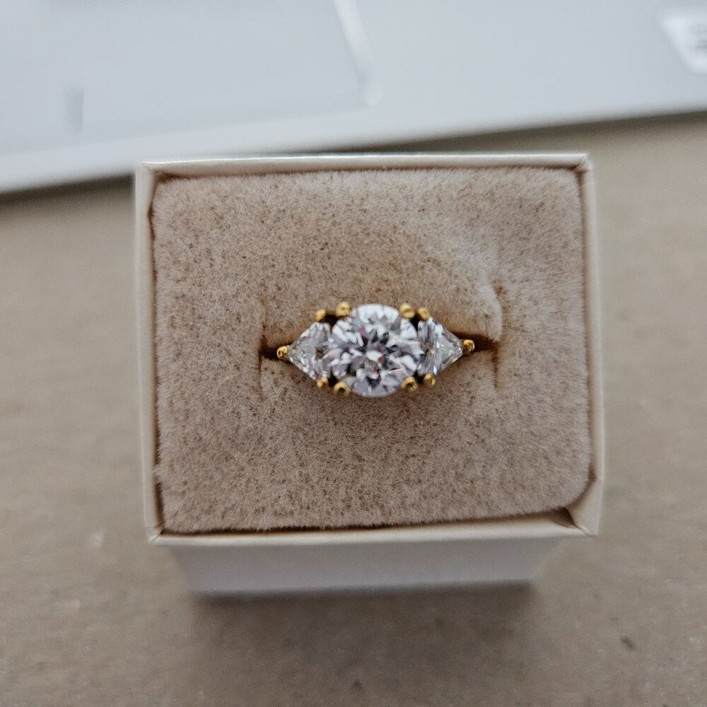 Three stone cubic zirconia and yellow gold-tone ring, size 5.